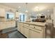 Well-lit kitchen featuring white cabinets, granite countertops, and stainless steel sink at 5515 Cheatam Ave, Cumming, GA 30040