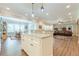 Bright open-concept kitchen featuring granite countertops and stainless steel appliances with seamless flow at 5515 Cheatam Ave, Cumming, GA 30040