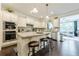 Modern kitchen with stainless steel appliances, granite countertops, and a breakfast bar at 5515 Cheatam Ave, Cumming, GA 30040