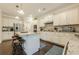 Spacious kitchen featuring white cabinets, granite counters, and stainless steel appliances at 5515 Cheatam Ave, Cumming, GA 30040