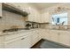 Bright kitchen with granite countertops, a gas range, and custom backsplash at 5515 Cheatam Ave, Cumming, GA 30040