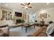 Inviting living room featuring a stone fireplace, built-in cabinets, and hardwood floors at 5515 Cheatam Ave, Cumming, GA 30040