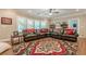 Large open living room with a comfortable sectional sofa, rug, and a ceiling fan at 5515 Cheatam Ave, Cumming, GA 30040
