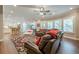 Open-concept living area featuring hardwood floors, kitchen, and inviting leather seating at 5515 Cheatam Ave, Cumming, GA 30040