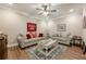Cozy living room with hardwood floors, a ceiling fan, and comfortable gray sofas at 5515 Cheatam Ave, Cumming, GA 30040