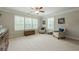 Spacious bedroom featuring a sitting area, large windows, neutral paint, and a ceiling fan at 5515 Cheatam Ave, Cumming, GA 30040
