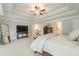 Large primary bedroom featuring a tray ceiling, plush carpet, a sitting area, and hallway access at 5515 Cheatam Ave, Cumming, GA 30040