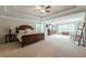 Spacious main bedroom with tray ceilings, plush carpeting, and large windows filling the room with natural light at 5515 Cheatam Ave, Cumming, GA 30040