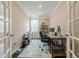 Home office featuring french doors, hardwood floors, built in desk, and lots of natural light at 5515 Cheatam Ave, Cumming, GA 30040