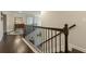 Staircase featuring hardwood floors and wrought iron railings at 5515 Cheatam Ave, Cumming, GA 30040