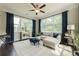 Cozy sunroom featuring bright windows, hardwood floors, and comfortable seating at 5515 Cheatam Ave, Cumming, GA 30040