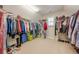 Walk-in closet with ample storage including shelving for shoes and hanging space for clothes at 5515 Cheatam Ave, Cumming, GA 30040