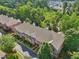 A beautiful aerial view of the townhouse community with mature trees and well-maintained landscaping at 1950 Buford Dam Rd # 205, Cumming, GA 30041