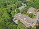 A picturesque view of charming townhomes with lush trees offering shade and privacy at 1950 Buford Dam Rd # 205, Cumming, GA 30041