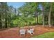 Backyard featuring white Adirondack chairs, ideal for relaxation among the lush greenery at 1950 Buford Dam Rd # 205, Cumming, GA 30041