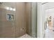 Elegant shower featuring neutral tile work, a niche, and a frameless glass shower door at 1950 Buford Dam Rd # 205, Cumming, GA 30041