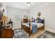 Well-lit bedroom with queen bed, vintage furnishings and plantation shutters at 1950 Buford Dam Rd # 205, Cumming, GA 30041