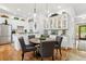 Dining area with a round table set for four, white cabinets, and hardwood flooring throughout the room at 1950 Buford Dam Rd # 205, Cumming, GA 30041
