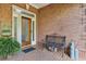 Inviting entryway with a decorative glass door, brick floor, and sitting bench at 1950 Buford Dam Rd # 205, Cumming, GA 30041