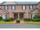 Charming brick townhome with a beautifully landscaped front yard and covered entryway at 1950 Buford Dam Rd # 205, Cumming, GA 30041