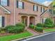Charming brick townhome with a landscaped front yard and covered entryway at 1950 Buford Dam Rd # 205, Cumming, GA 30041