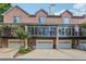 Exterior shot showcasing townhome garages and balconies with wrought iron railing at 1950 Buford Dam Rd # 205, Cumming, GA 30041