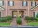 Charming brick townhome with a beautifully landscaped front yard and covered entryway at 1950 Buford Dam Rd # 205, Cumming, GA 30041