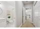 Hallway view featuring a bathroom, open door leading to a bedroom and multiple closets at 1950 Buford Dam Rd # 205, Cumming, GA 30041
