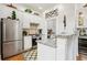 A bright kitchen featuring stainless steel appliances, white cabinets, and a breakfast bar with granite countertops at 1950 Buford Dam Rd # 205, Cumming, GA 30041