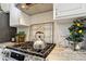 Close up of the kitchen featuring a gas stove, white cabinets, and a decorative backsplash with light granite counters at 1950 Buford Dam Rd # 205, Cumming, GA 30041