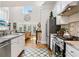 Bright kitchen with stainless steel appliances, white cabinets, and a view into the living room with a fireplace at 1950 Buford Dam Rd # 205, Cumming, GA 30041