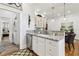 A kitchenette with granite countertops, stainless steel appliances, and white cabinets, with a laundry room on the side at 1950 Buford Dam Rd # 205, Cumming, GA 30041