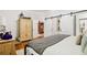 Spacious main bedroom boasting an armoire and barn doors to the walk-in closet at 1950 Buford Dam Rd # 205, Cumming, GA 30041
