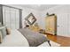 Well-lit main bedroom showcasing hardwood floors, plantation shutters, and comfortable furnishings at 1950 Buford Dam Rd # 205, Cumming, GA 30041
