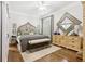 Main bedroom with hardwood flooring, large dresser, and a neutral color scheme with a ceiling fan at 1950 Buford Dam Rd # 205, Cumming, GA 30041