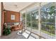 Relaxing sunroom with brick accent wall, telescope, and large windows offering stunning views at 1950 Buford Dam Rd # 205, Cumming, GA 30041