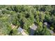 An aerial view of a home nestled among mature trees, offering privacy and a serene setting at 3627 Spring Meadow Court, Acworth, GA 30101