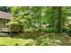 Expansive backyard with mature trees providing shade and privacy, ideal for outdoor gatherings at 3627 Spring Meadow Court, Acworth, GA 30101