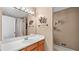 Neutral bathroom with a large vanity, lighted mirror, and a shower with a curtain at 3627 Spring Meadow Court, Acworth, GA 30101