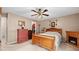 Serene bedroom with ceiling fan, wood furniture, a faux fireplace, and a bright window at 3627 Spring Meadow Court, Acworth, GA 30101
