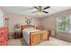 Comfortable bedroom with a ceiling fan, a window with natural light, and wood furniture at 3627 Spring Meadow Court, Acworth, GA 30101