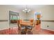 Inviting dining room featuring hardwood floors, a chandelier, and a view into the living room at 3627 Spring Meadow Court, Acworth, GA 30101