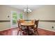 Cozy dining room with hardwood floors, a round table, and a view of the backyard at 3627 Spring Meadow Court, Acworth, GA 30101