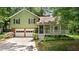 Charming two-story home with a brick foundation, a front porch, and a two-car garage at 3627 Spring Meadow Court, Acworth, GA 30101