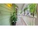 Inviting front porch with a green exterior and a view of the surrounding landscape at 3627 Spring Meadow Court, Acworth, GA 30101