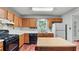 Functional kitchen with wooden cabinets, laminate countertops, and standard appliances at 3627 Spring Meadow Court, Acworth, GA 30101