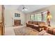 Comfortable living room featuring a fireplace, a bay window, and a neutral color scheme at 3627 Spring Meadow Court, Acworth, GA 30101