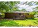 Backyard of a brick home featuring a wooden deck, manicured lawn, and mature trees at 379 Utoy Sw Cir, Atlanta, GA 30331