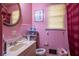 Charming pink bathroom with tiled walls, vanity, toilet, and shower at 379 Utoy Sw Cir, Atlanta, GA 30331