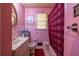 This bathroom is pink with a pink shower curtain at 379 Utoy Sw Cir, Atlanta, GA 30331
